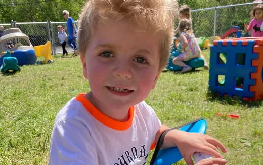 a boy smiling at the camera