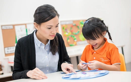 a woman and a child looking at a paper