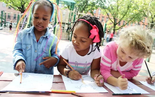 a group of children sitting at a table
