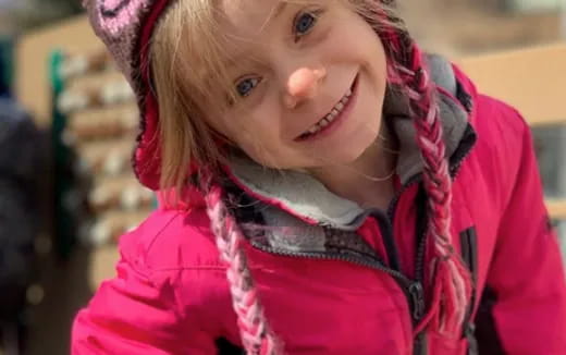 a girl wearing a red jacket