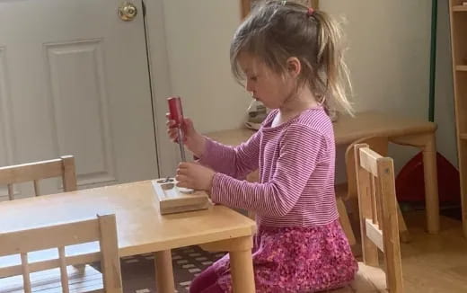 a little girl playing with a remote control