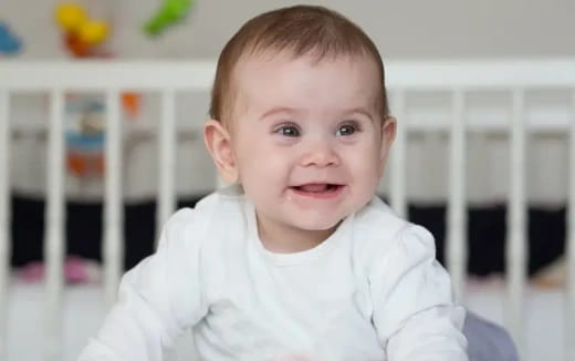 a baby smiling for the camera