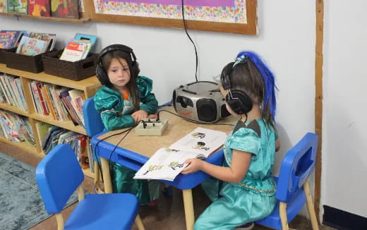 a few young girls wearing headphones