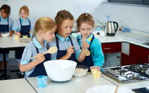 a group of children in a kitchen