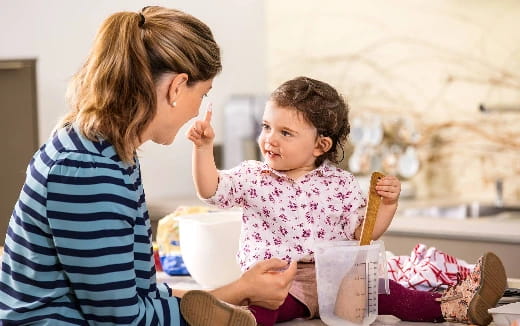 a woman feeding a baby