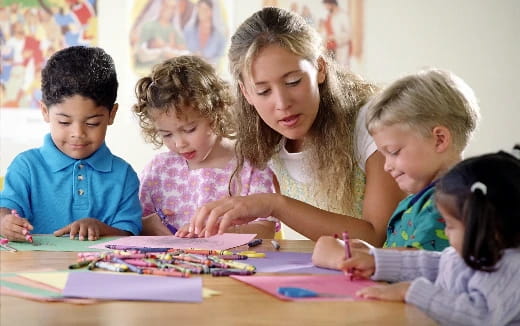 a group of children sitting at a table