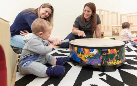 a person and a child playing with a cake