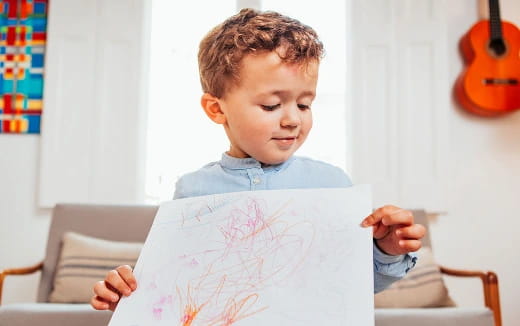 a child holding a piece of paper