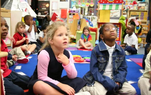 a group of children sitting in a classroom