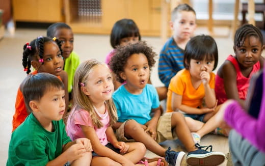 a group of children sitting on the floor