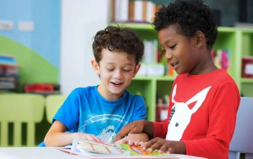 medium shot of kids looking at a book