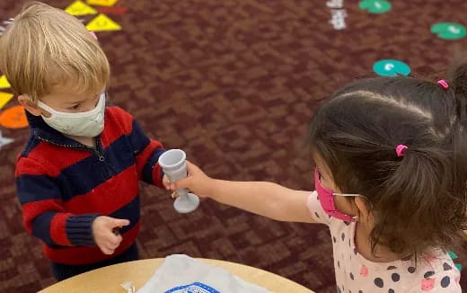 a child and a girl playing with sand