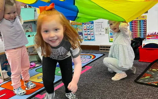 a group of children playing on a playground toy