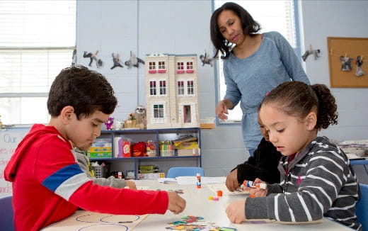a person and children sitting at a table