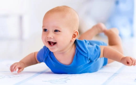 a baby crawling on a white surface