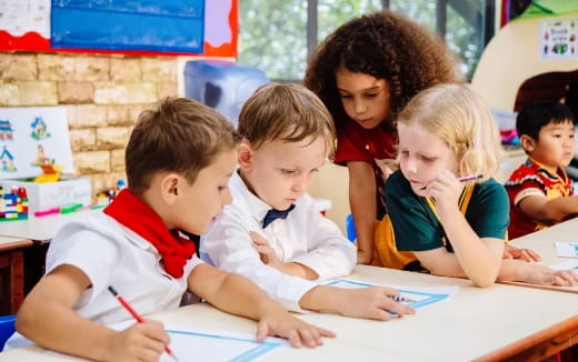 a group of children sitting at a table