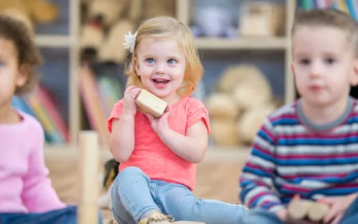 a young girl holding a phone