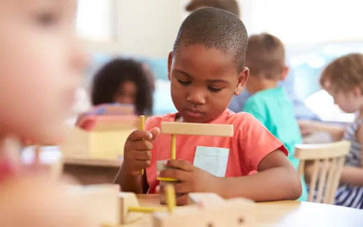 a young boy sitting at a table
