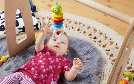 a baby lying on a blanket