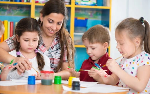 a person and children painting