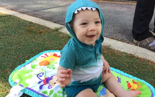a baby sitting on a colorful slide