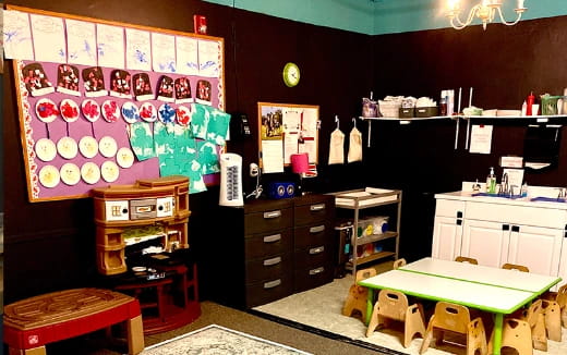 a room with a desk and shelves