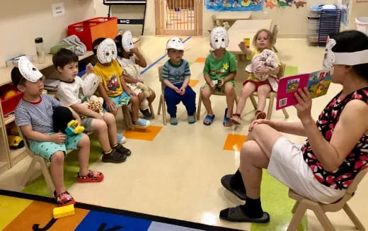 a group of children sitting in chairs