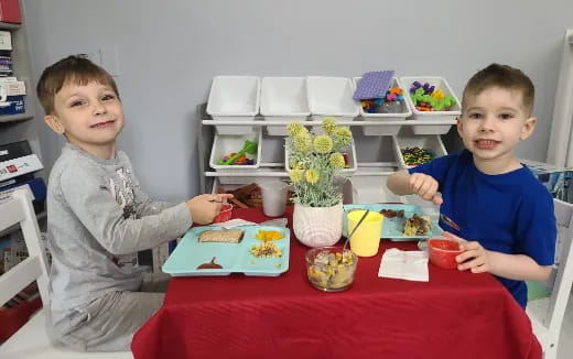 two boys sitting at a table