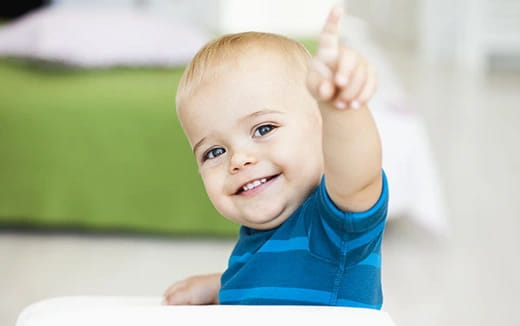 a baby with a thumbs up