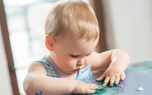 a baby playing with water