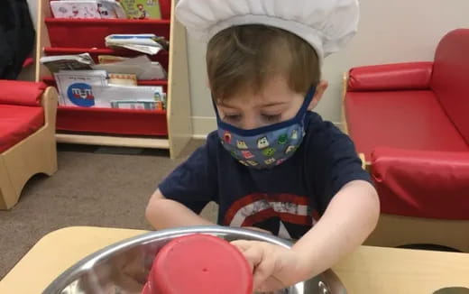 a boy playing with a bowl