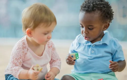 a couple of children holding a card