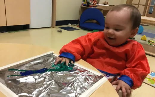 a baby playing with plastic toys