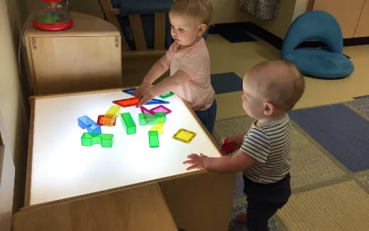 two babies playing with toys