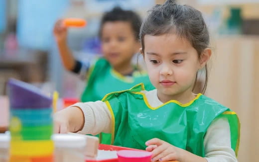 a young girl in a green shirt
