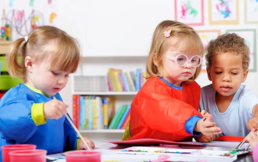 a group of children sitting at a table