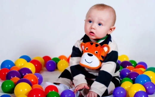a baby in a ball pit