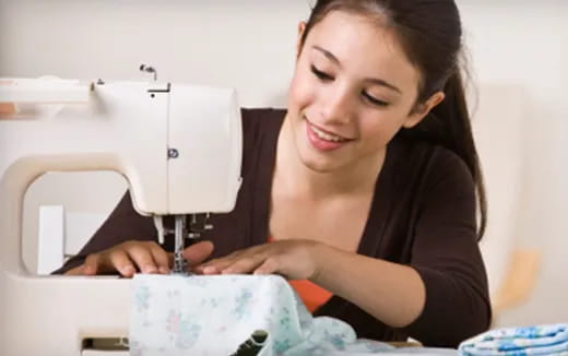 a woman looking at a microscope