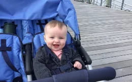 a baby sitting in a stroller