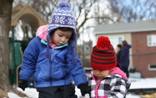 a couple of children in winter clothes