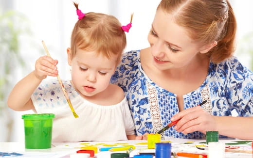 a person and a child painting