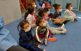 a group of children sitting on the floor
