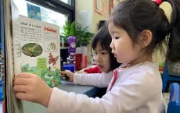 medium shot of kids looking at a paper