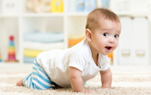 a baby crawling on the floor