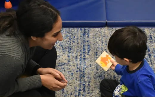 a person and a child sitting on the ground