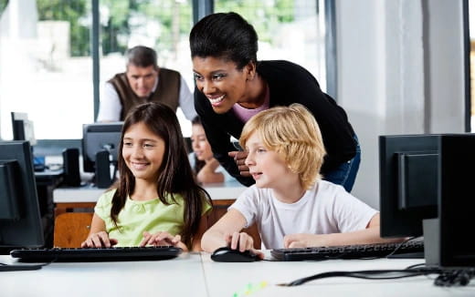 a group of people looking at a computer screen