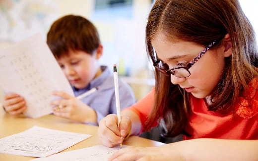 a woman and a boy studying