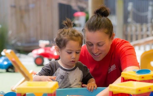 a person and a child playing with toys