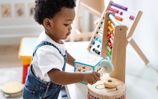 a young boy playing with a toy
