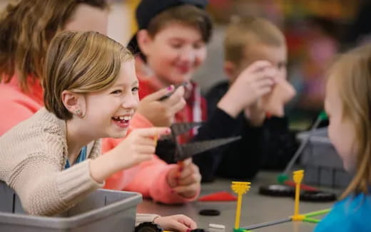 a group of children sitting at a table